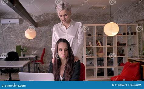 busty masseuse|Young blonde lesbian massaging woman in modern office during .